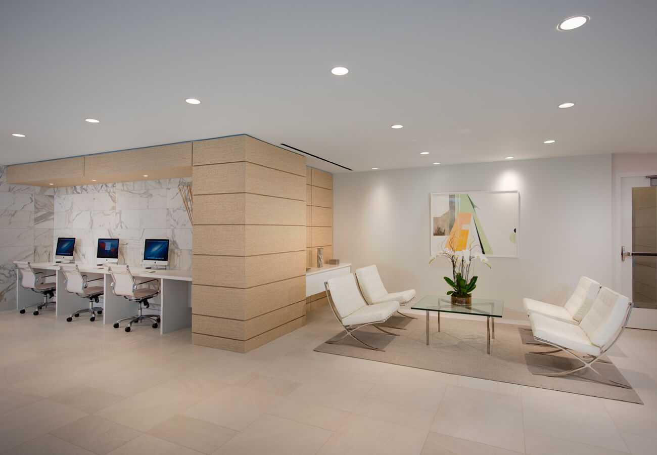 Business center at Fifty Three Thirty Three Apartments with computer workstations and lounge seating