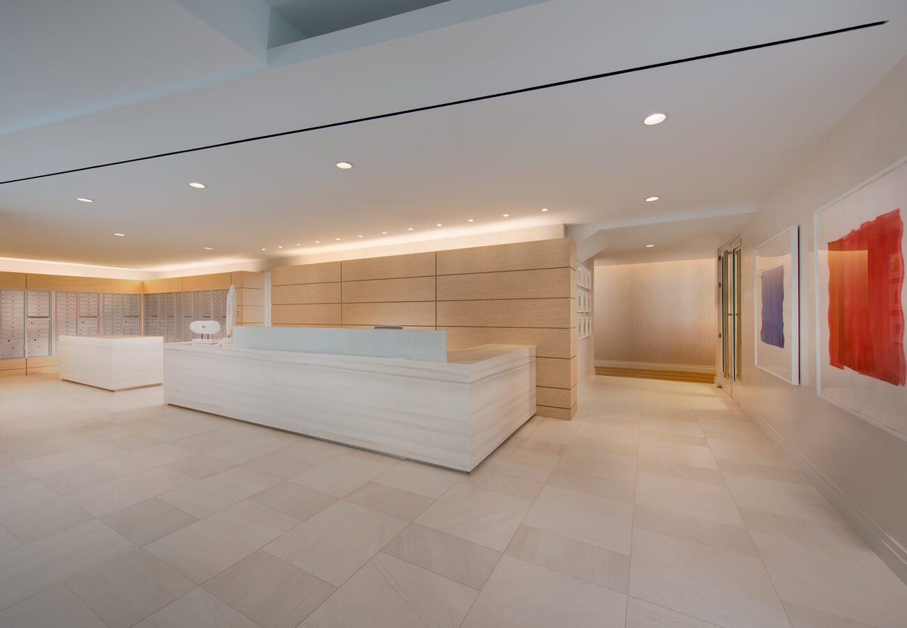 Concierge desk at Fifty Three Thirty Three Apartments with mailboxes, marble counter, and lobby artwork