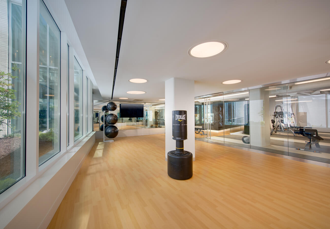 Fitness studio at Fifty Three Thirty Three Apartments with punching bag, exercise balls, and mirrored workout area
